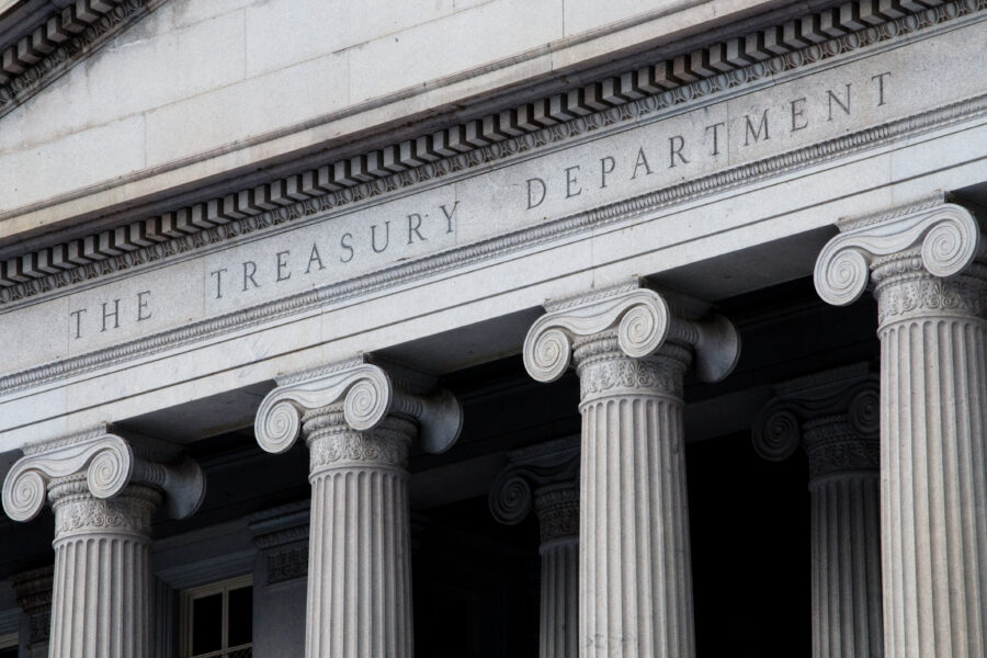 facade of the US Treasury building, with four columns underneath the title